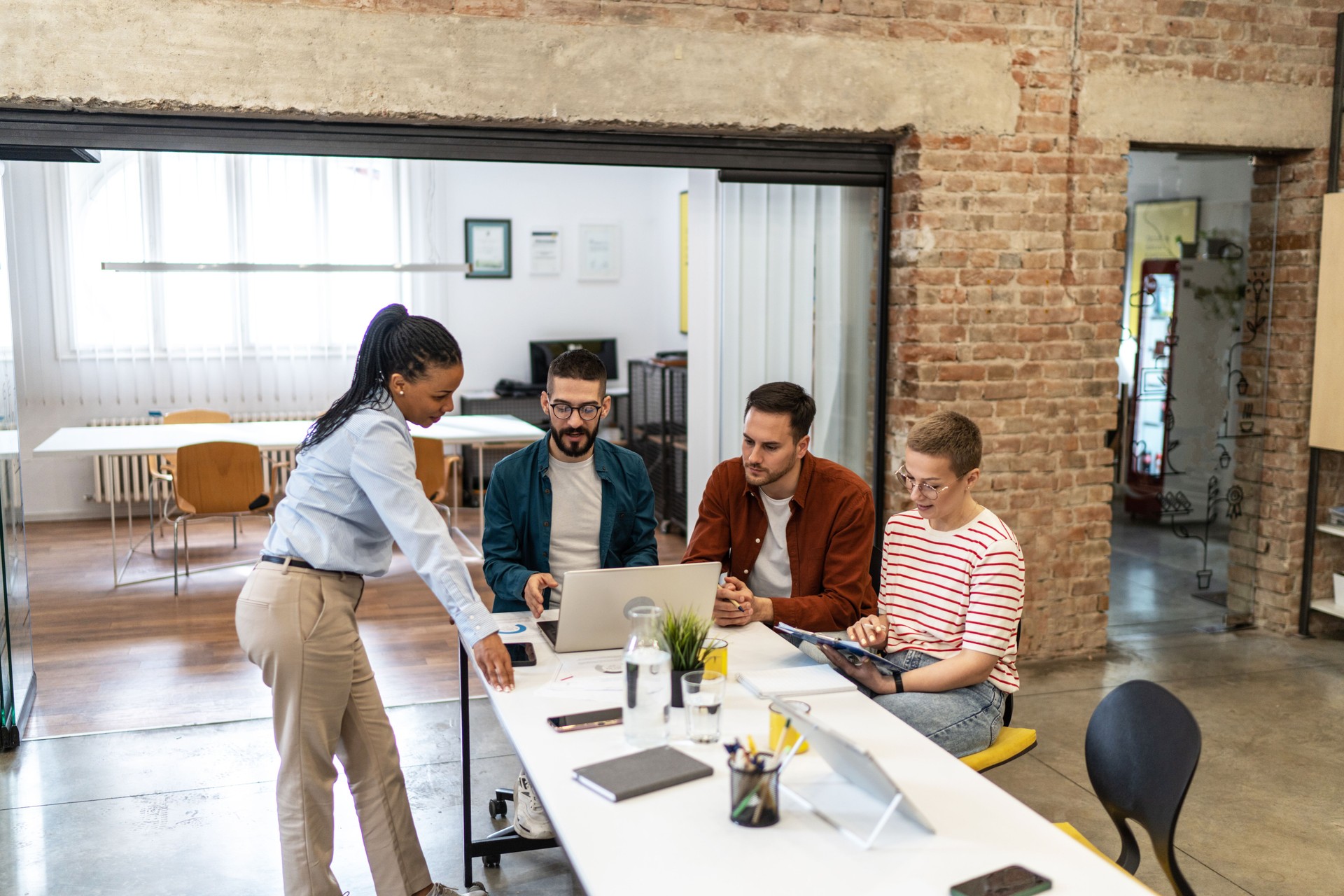 Cheerful coworkers in modern office during company meeting